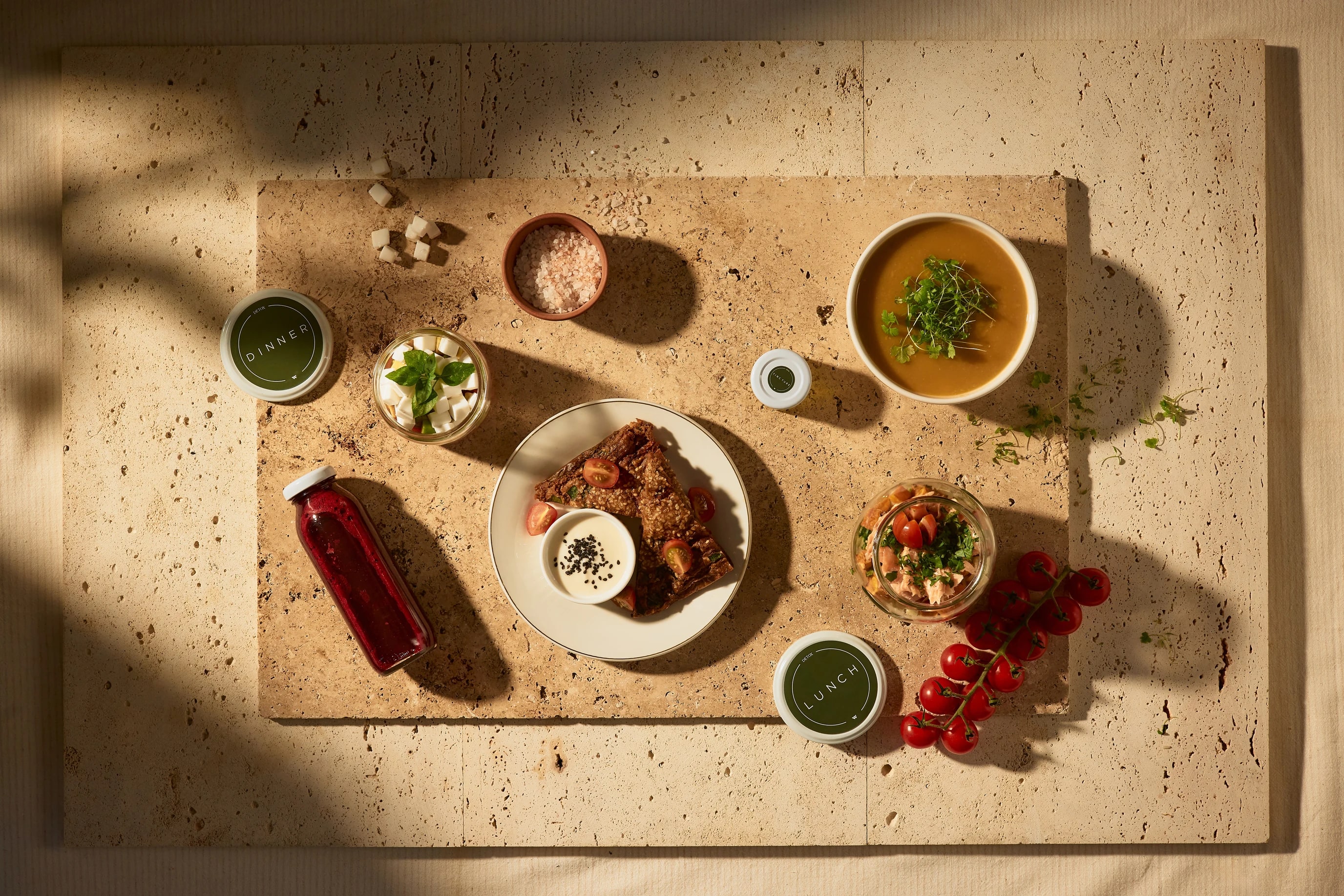WAGA prepared meals and juices arranged on stone